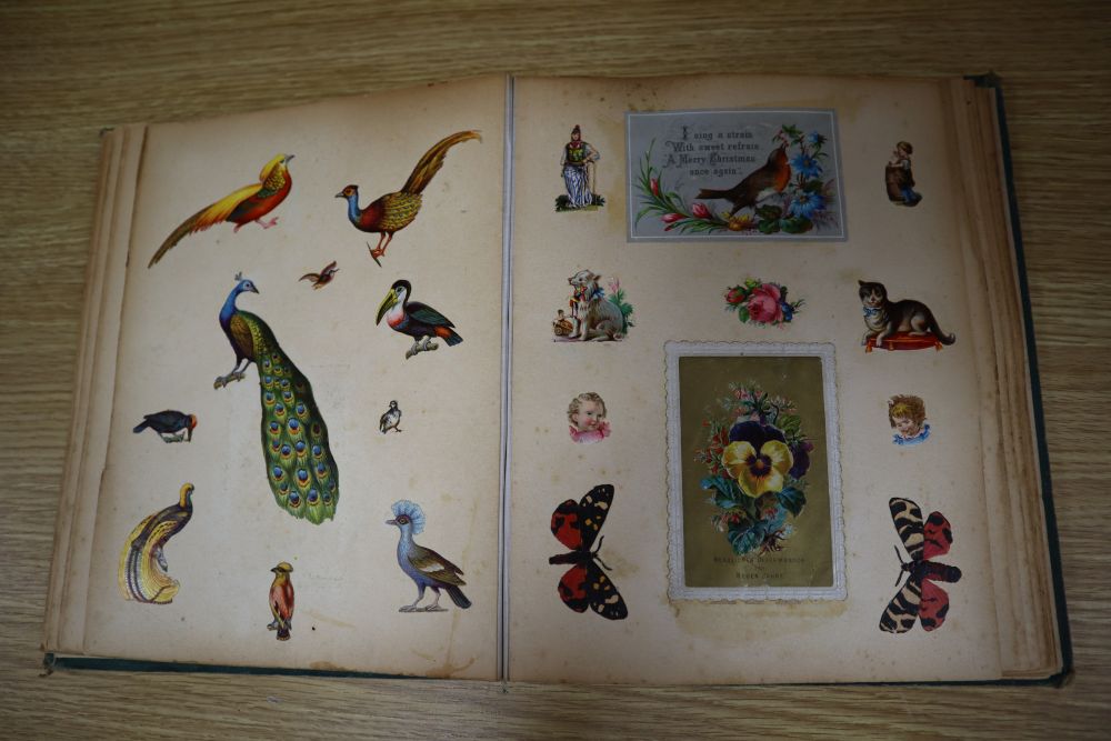 A Victorian scrap album, containing chromolithographic cards and scraps and pressed leaves and two other items,